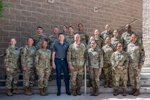The Honorable Alex Wagner, Assistant Secretary of the Air Force for Manpower and Reserve Affairs, and Chief Master Sgt. of the Air Force David Flosi, pose for a group photo with Airmen during a visit to Nellis Air Force Base, Nevada, May 7, 2024.