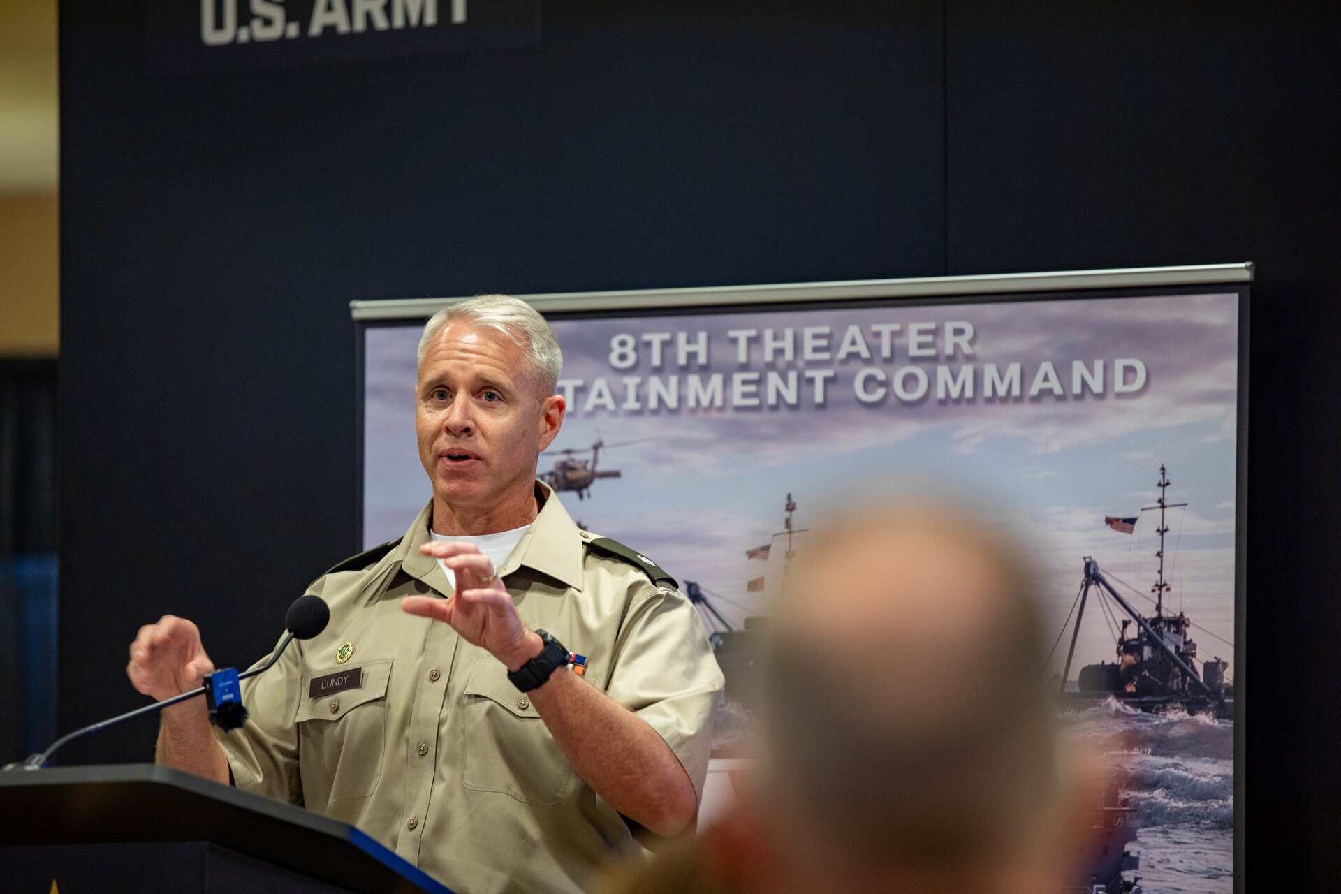 U.S. Army Lt. Col. Shayne Lundy, deputy commanding officer of the 8th Military Police Brigade, speaks on the unique capabilities of the 8th Military Police Brigade during Land Forces Pacific Symposium 2024 Honolulu, Hawaii, May 15, 2024. LANPAC allows the military to highlight their vital role in the Pacific theater. (U.S. Army photo by Spc. Devin Davis)