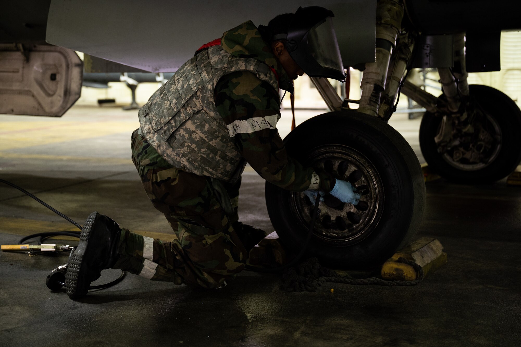 U.S. Air Force Airman 1st Class Noah Woulard, 36th Fighter Generation Squadron assistant dedicated crew chief, services a tire on an F-16 Fighting Falcon during Beverly Herd 24-1 at Osan Air Base, Republic of Korea, May 15, 2024. The 36th FGS aircraft are loaded with ordnance to enable lethal airpower and train for contingency operations. Routine training events like Beverly Herd are pivotal platforms for 51st Fighter Wing Airmen to refine their warfighting proficiencies through practical application, concurrently enhancing their ability to respond skillfully to contingencies. (U.S. Air Force photo by Tech. Sgt. Clayton Lenhardt)