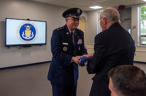 Chaplain (Maj. Gen.) Randall Kitchens, U.S. Air Force Chief of Chaplains, presents a flag to retired Chaplain (Maj. Gen.) Charles Baldwin, former Air Force Chief of Chaplains, at Joint Base Andrews, Md., May 10, 2024
