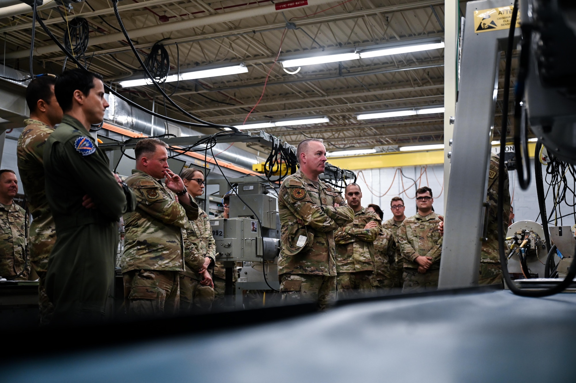 U.S. Air Force Chief Master Sgt. David Wolfe, command chief of Air Combat Command, receives a brief from the 36th Electronic Warfare Squadron’s pod shop team during a tour of the 350th Spectrum Warfare Wing by the ACC Command Team at Eglin Air Force Base, Florida, April 12, 2024. The pods are used in testing mission data files that allow aircraft to sense, identify, locate, and counter electronic warfare threats. (U.S. Air Force photo by Capt. Benjamin Aronson)