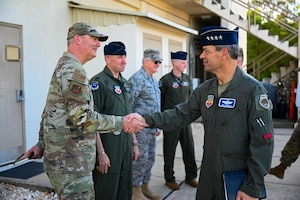 U.S. Air Force Gen. Ken Wilsbach, commander of Air Combat Command shakes hands with Chief Master Sgt. Jason Vollmer, 350th Spectrum Warfare Group senior enlisted leader, during his tour of the 350th Spectrum Warfare Wing at Eglin Air Force Base, Florida, April 12, 2024. The mission of the 350th SWW is to deliver adaptive and cutting-edge electromagnetic spectrum capabilities that provide the warfighter a tactical and strategic competitive advantage and freedom to attack, maneuver, and defend. (U.S. Air Force photo by Capt. Benjamin Aronson)