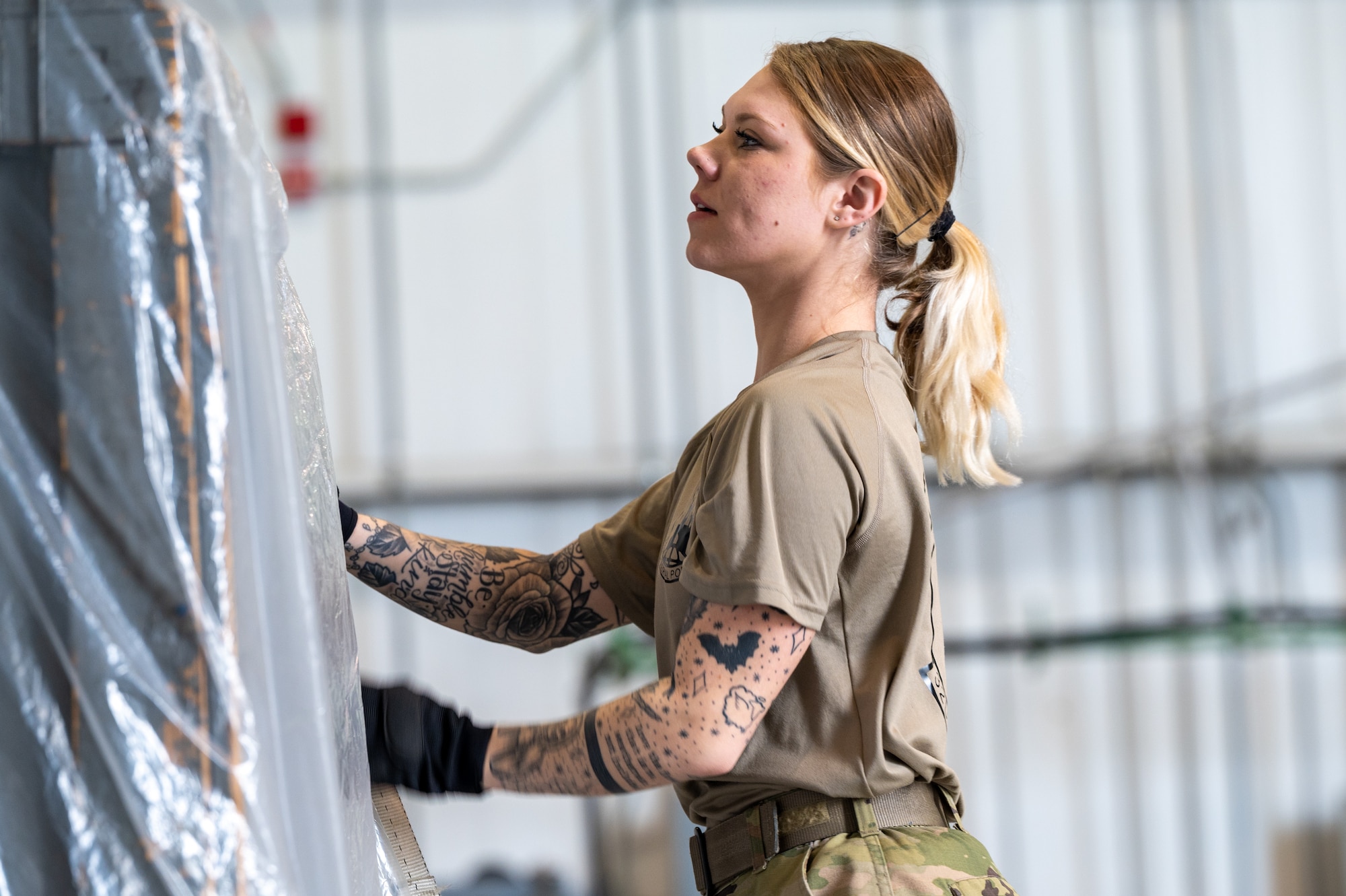 Staff Sgt. Angeliya Tango, special handling representative at the 32nd Aerial Port Squadron, secures cargo restraints during the Pallet Build Up challenge at the 2024 Port Dawg Challenge at Dobbins Air Reserve Base, Georgia, April 17, 2024. One of air transportation specialists’s responsibilities is to build pallets that will remain secure in flight and to ensure the contents of the cargo match the inventory. (U.S. Air Force photo by Master Sgt. Diana E. Ferree)