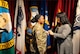 Female U.S. Army Soldier getting promoted by friend during promotion ceremony