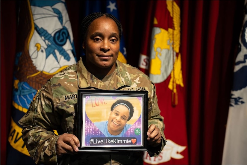 Female U.S. Army Soldier holding a picture frame