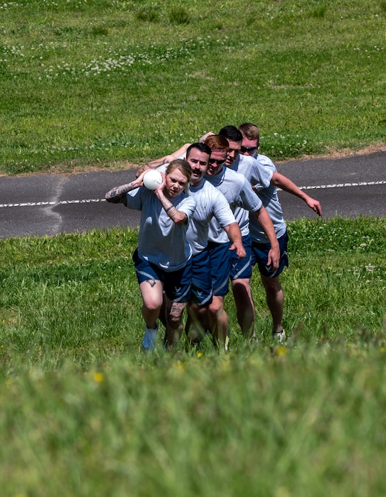 The 32nd Aerial Port Team carries “The Bone” to the finish line of the Fit to Fight event during the 2024 Port Dawg Challenge at Dobbins Air Reserve Base, Georgia, April 18, 2024. “The Bone” is a long PVC pipe filled with water and golf balls, it was the final obstacle during the Fit to Fight challenge. (U.S. Air Force photo by Master Sgt. Diana E. Ferree)