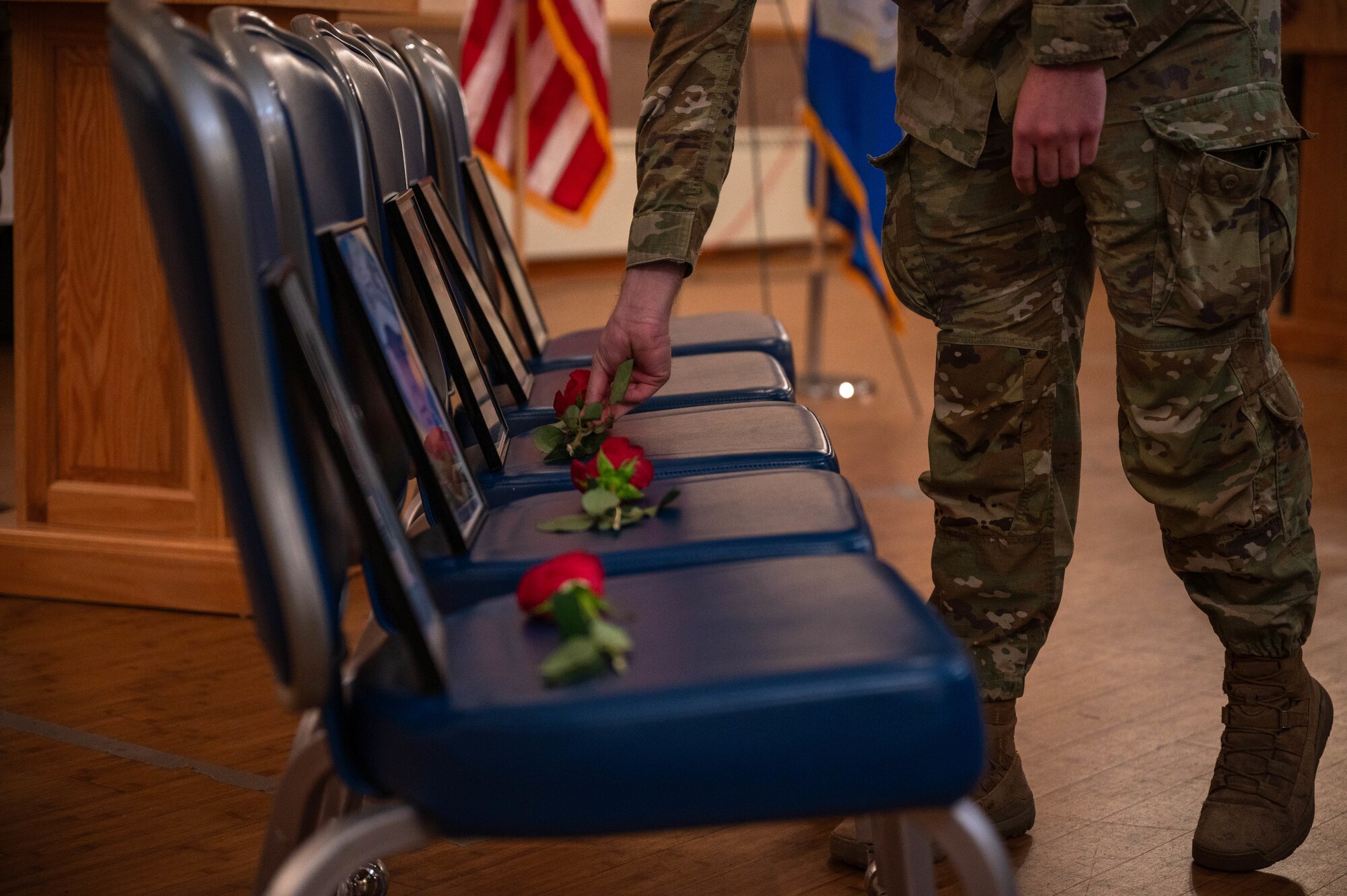 Airmen set roses during police week.