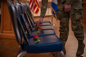 Airmen set roses during police week.