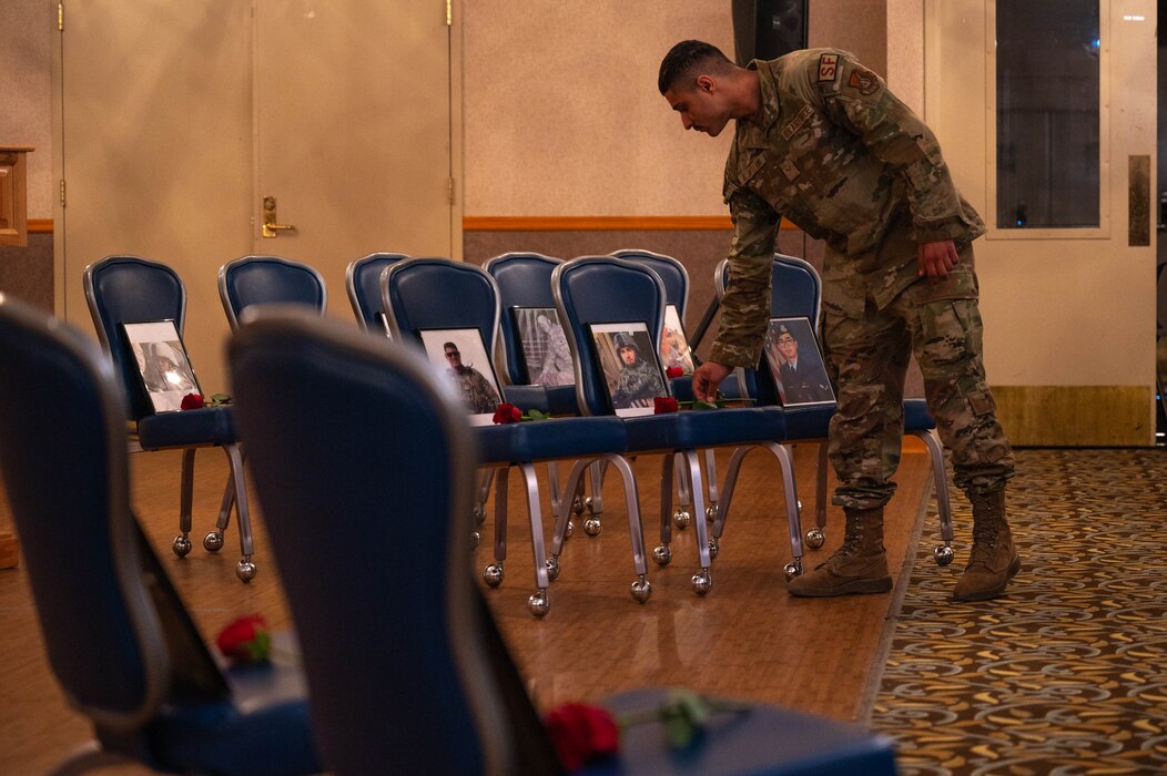 Airmen set roses during police week.