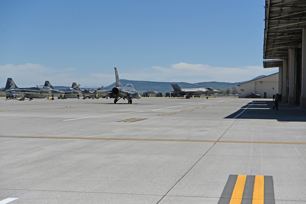 A U.S. Air Force F-16 Fighting Falcon from the 309th Fighter Squadron out of  Luke Air Force Base, Arizona, taxis to the runway  in preperation for a training mission as a Luke AFB F-35 Lightning II returns at Kingsley Field in Klamath Falls, Oregon, May 14, 2024.