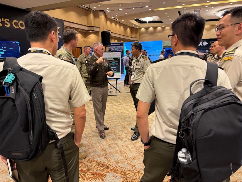 U.S. Army Brig. Gen. Bernard Harrington, commander of the 1st Multi-Domain Task Force (1MDTF) discusses the Combined Information and Effects Fusion Cell (CIEFC) with Singapore Army Brig. Gen. Tan Cheng Kwee at the Association of the United States Army (AUSA) LANPAC Symposium, Honolulu, Hawaii, May 15, 2024. Over three days, 1MDTF showcased the CIEFC's capabilities to a global audience of military professionals, industry leaders, and subject matter experts.  (U.S. Army photo by Staff Sgt. Brandon Rickert)