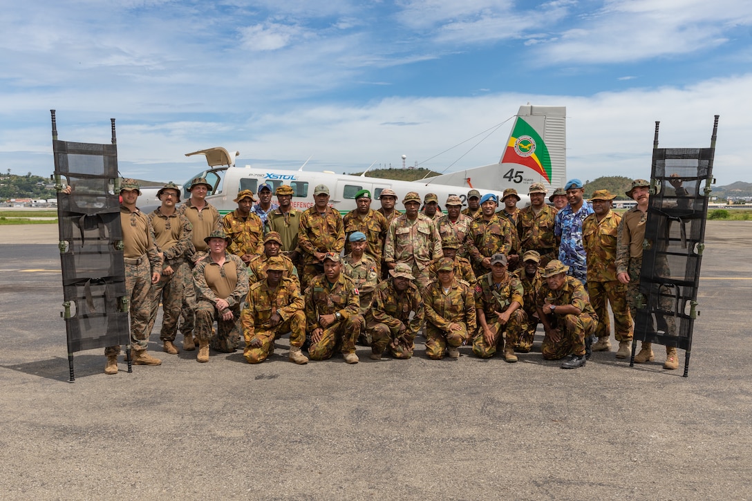 U.S. Sailors with Marine Rotational Force – Darwin 24.3 pose for a photo with Papua New Guinea Defence Force members after an en route care orientation at the Air Transport Wing, Port Moresby, Papua New Guinea, May 8, 2024. The HADR exercise is conducted in coordination with the Papua New Guinea Defence force and U.S. Embassy in Port Moresby, with a focus on projecting select role II medical, logistics, and Marine Air-Ground Task Force command and control capabilities off-continent, to validate HADR training and readiness. (U.S. Marine Corps photo by Cpl. Juan Torres)