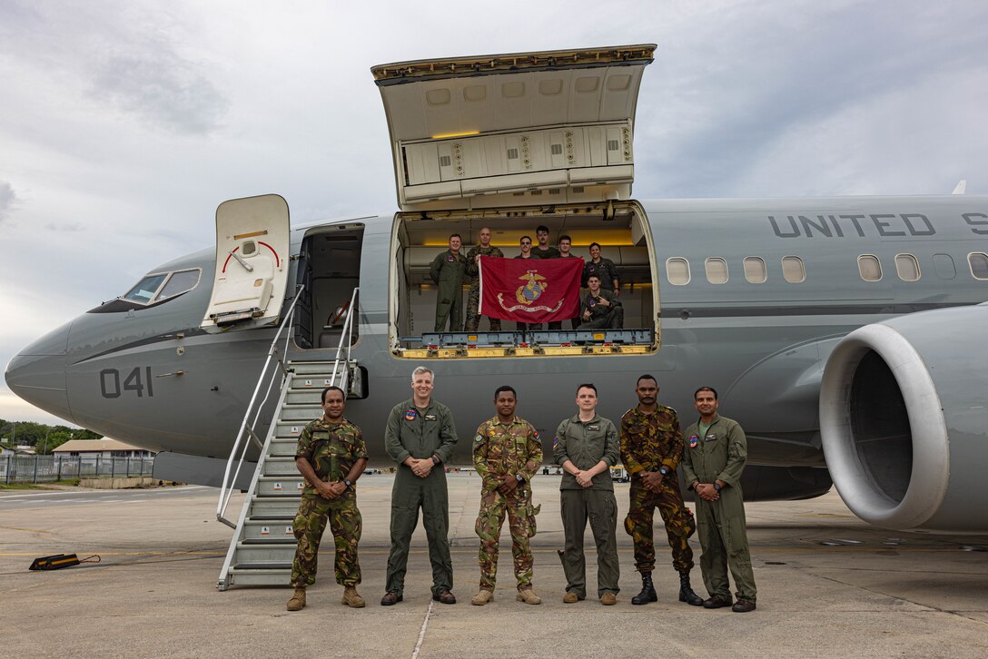 U.S. Marines with Marine Transport Squadron 1, Marine Aircraft Group 41, 4th Marine Aircraft Wing, Marine Forces Reserve, pose for a photo with Papua New Guinea Defence Force members in front of a C-40A assigned to VMR-1, MAG-41, in support of Marine Rotational Force – Darwin 24.3 as part of a humanitarian aid and disaster relief exercise at Jacksons International Airport, Port Moresby, Papua New Guinea, April 30, 2024. The HADR exercise will be conducted in coordination with the PNGDF and U.S. Embassy in Port Moresby, with a focus on projecting select Role II medical, logistics, and Marine Air-Ground Task Force command and control capabilities off-continent, to validate HADR training and readiness. MRF-D 24.3 remains committed to maintaining readiness and fostering partnerships to ensure a swift and effective response to humanitarian crises wherever and whenever they may occur. (U.S. Marine Corps photo by Cpl. Juan Torres)