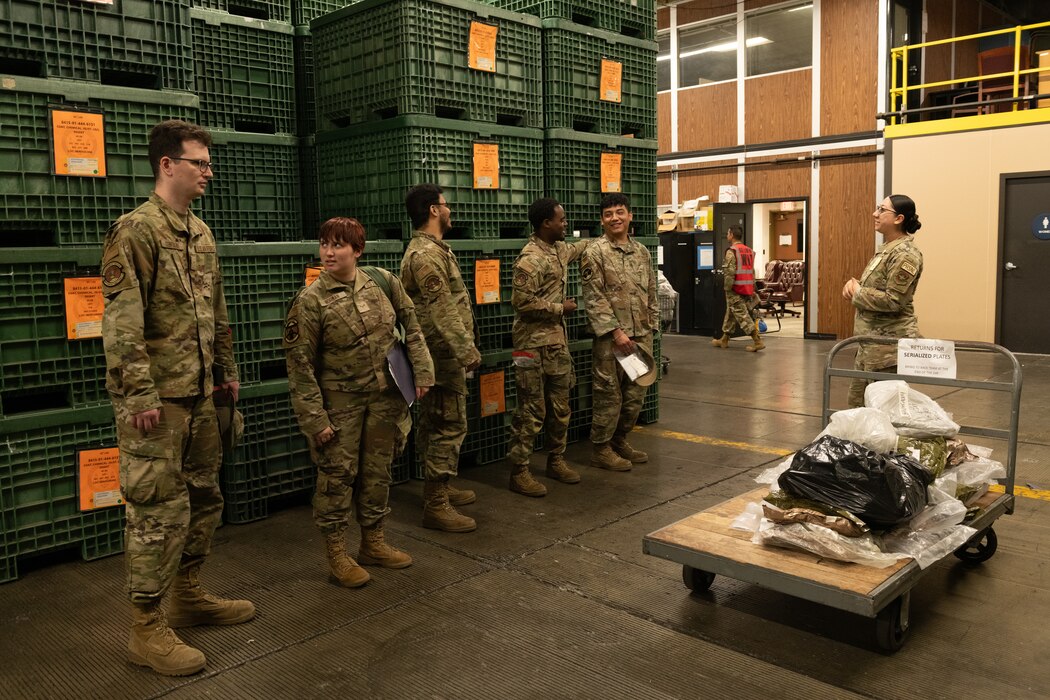 U.S. Airmen stand in a processing line.
