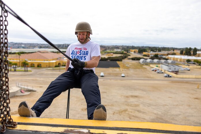 Sheldon Card, a teacher in Pleasantville, Iowa, takes the first steps to descend the rappel tower during an Educators’ Workshop at Marine Corps Recruit Depot San Diego, Calif., April 25, 2024. Educators with Recruiting Stations Chicago, St. Louis, and Kansas City attended EWS, which is designed to inform high school/college educators, community leaders, and communication professionals about the commitment and benefits of service in the U.S. Marine Corps. (U.S. Marine Corps photo by Sgt. Reagan E. Anderson)