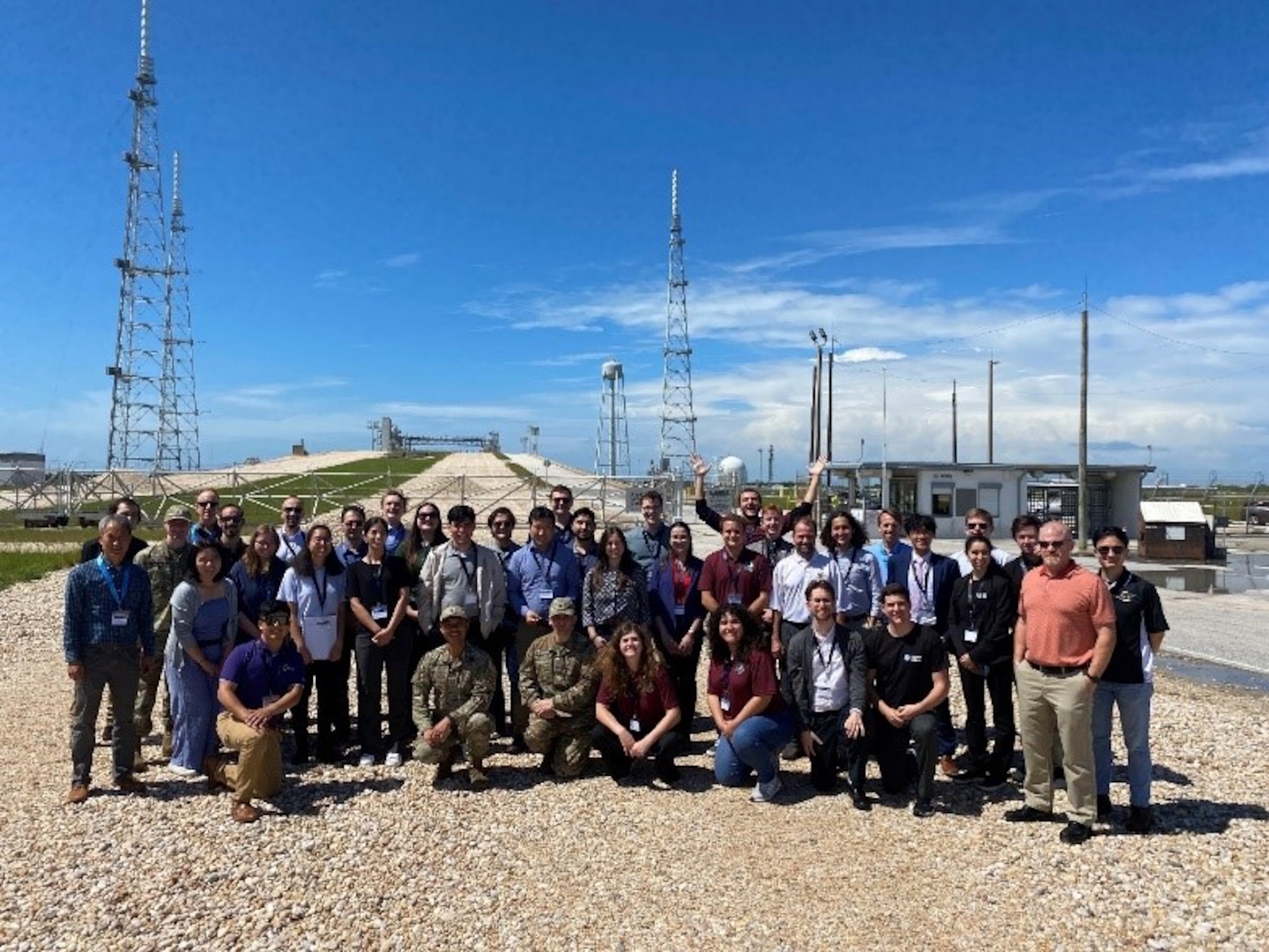 Air Force Research Laboratory staff stand with university students