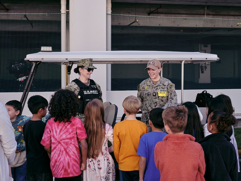Master-at-Arms 2nd Class Katarina Rowley (right) and Master-at-Arms 1st Class Mandi Huffaker (left), take questions from students about his job during The Sullivans Elementary School's first Car Career Day Friday, May 3, 2024 in Yokosuka, Japan.