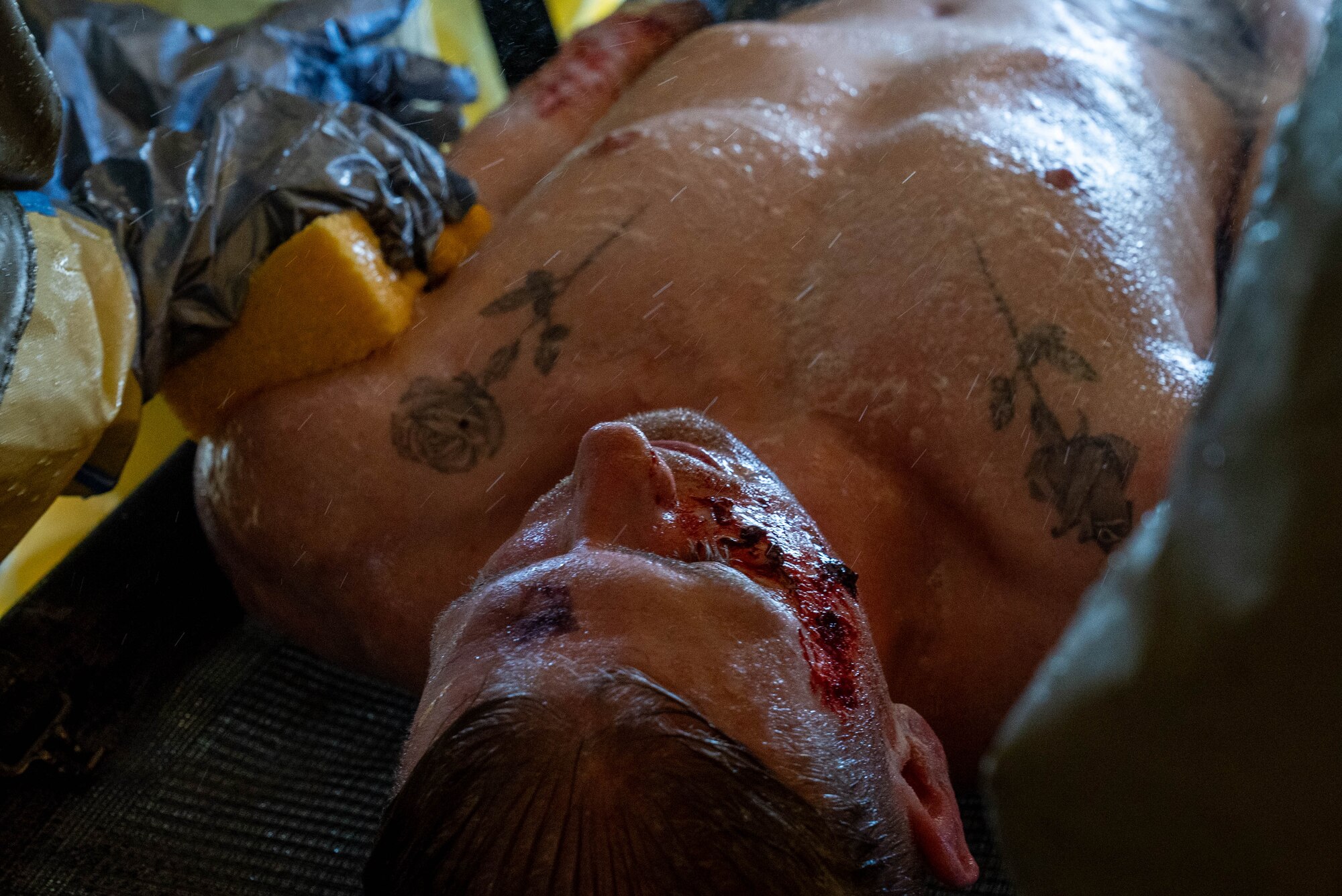 Airmen gets cleaned during a DECON shower