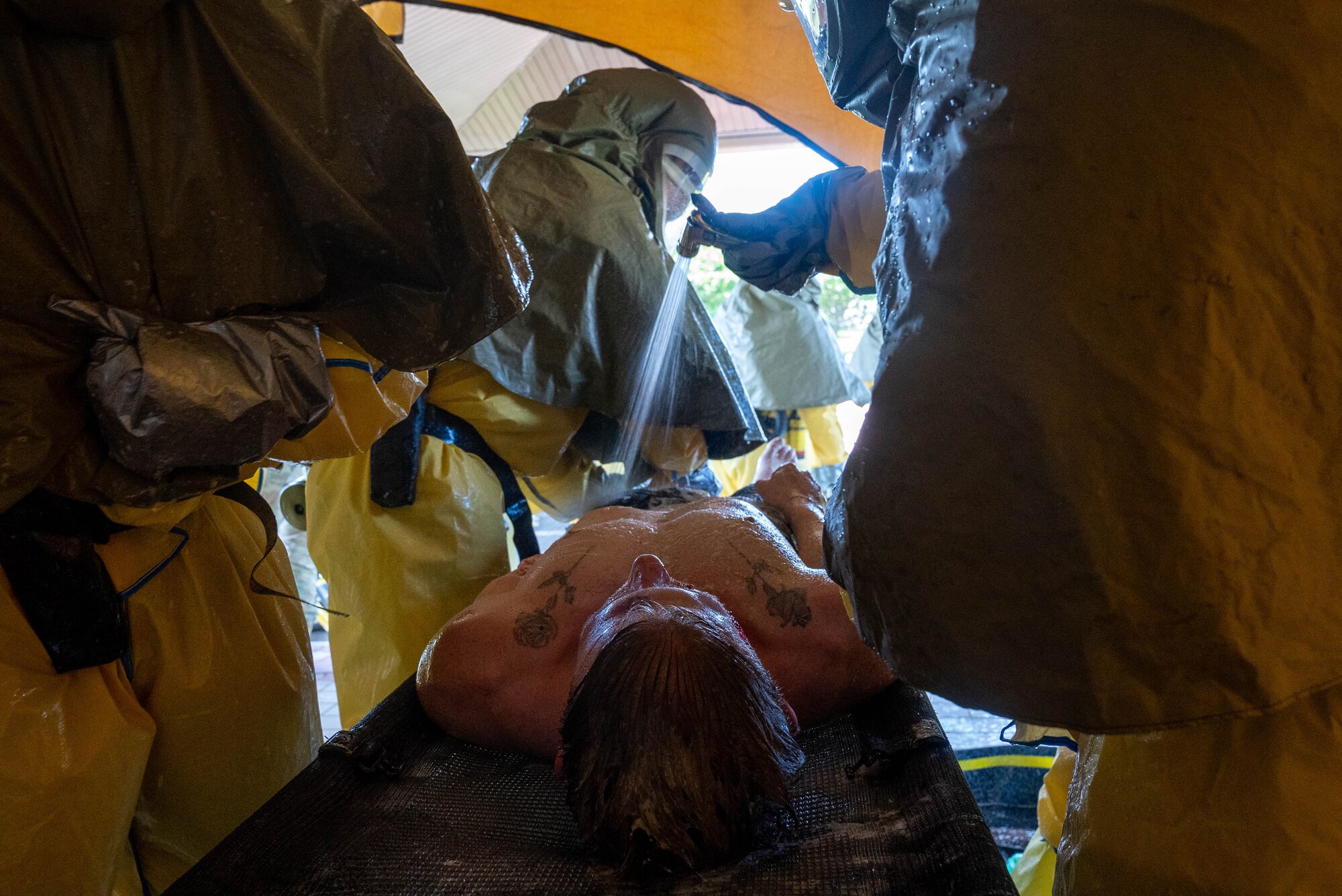 Airmen gets cleaned during a DECON shower