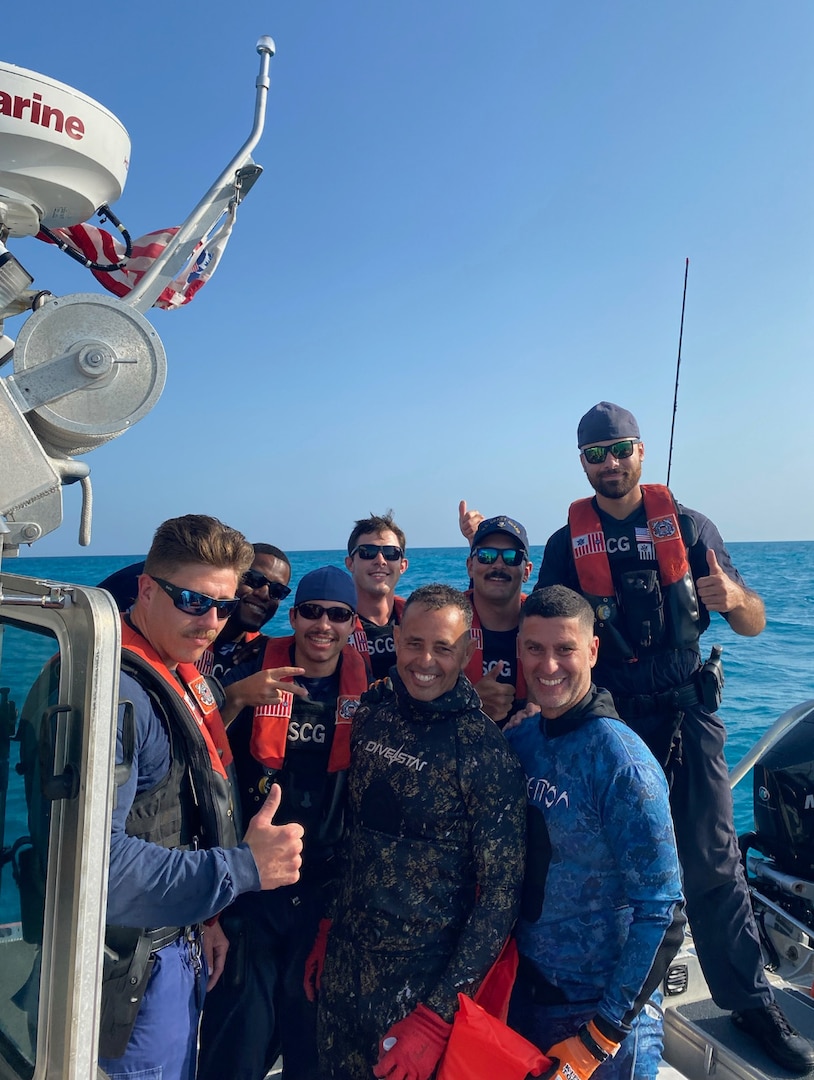 A U.S. Coast Guard Station Islamorada boat crew poses with two rescued free divers following their rescue near Tennessee Reef, Florida, on May 16, 2024. The crews respond to a 911 relay after the divers went missing for over an hour following a dive. (U.S. Coast Guard photo)