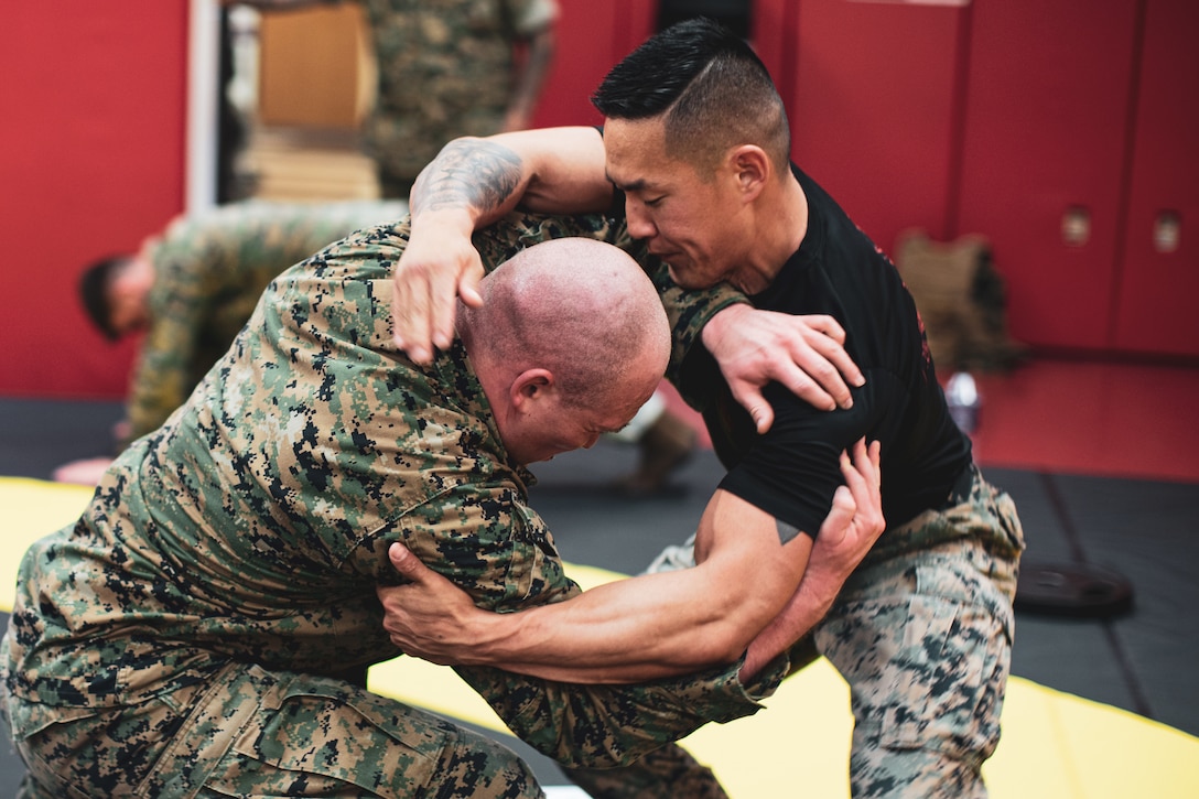 U.S. Marine Corps Lance Cpl. Jakob Mcentire, left, a Marine-Air Ground Task Force Planner, ground fights Capt. Daniel Kim, a Marine Corps Marital Arts Program Instructor, both with U.S. Marine Corps Forces Korea, during a Marine Corps Martial Arts Program training session at U.S. Army Garrison Humphreys, Republic of Korea, April 30, 2024. MCMAP is an integrated, weapons-based training system that incorporates the full spectrum of the force continuum on the battlefield and contributes to the mental and physical development of Marines. (U.S. Marine Corps photo by Cpl. Dean Gurule)