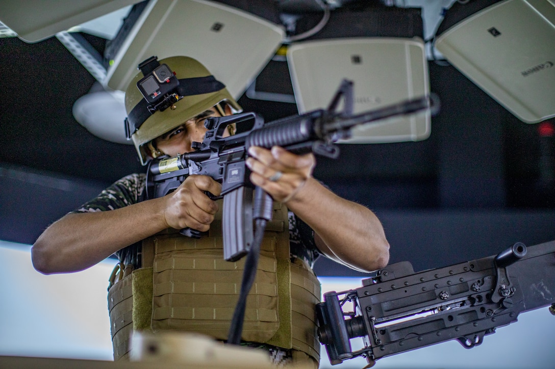 A U.S. Marine Corps spouse with Marine Corps Forces Korea, fires at targets in a reconfigurable vehicle simulator during Jayne Wayne day at U.S. Army Garrison Humphreys, South Korea, May 3, 2024. Jayne Wayne day strengthens camaraderie and gives spouses a more solid understanding of what their service member does daily and builds intercultural bonds. (U.S. Marine Corps photo by Cpl. Dean Gurule)