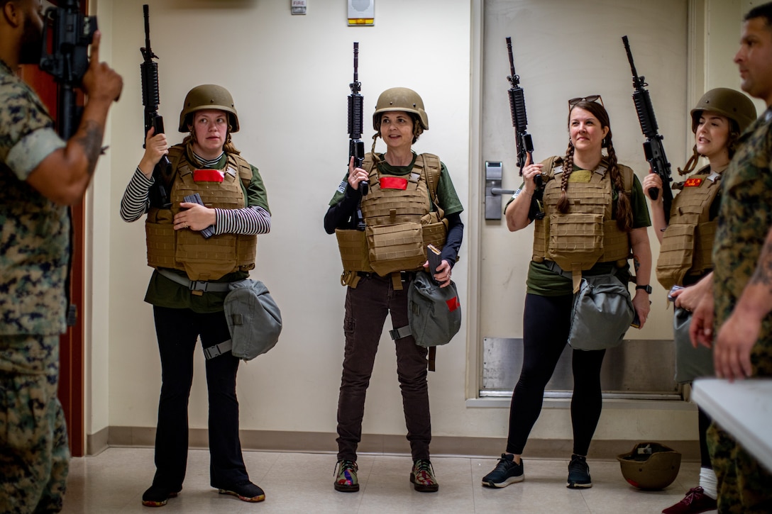 U.S. Marine Corps spouses with Marine Corps Forces Korea, receive a weapons brief during Jayne Wayne day at U.S. Army Garrison Humphreys, South Korea, May 3, 2024. Jayne Wayne day strengthens camaraderie and gives spouses a more solid understanding of what their service member does daily and builds intercultural bonds. (U.S. Marine Corps photo by Cpl. Dean Gurule)