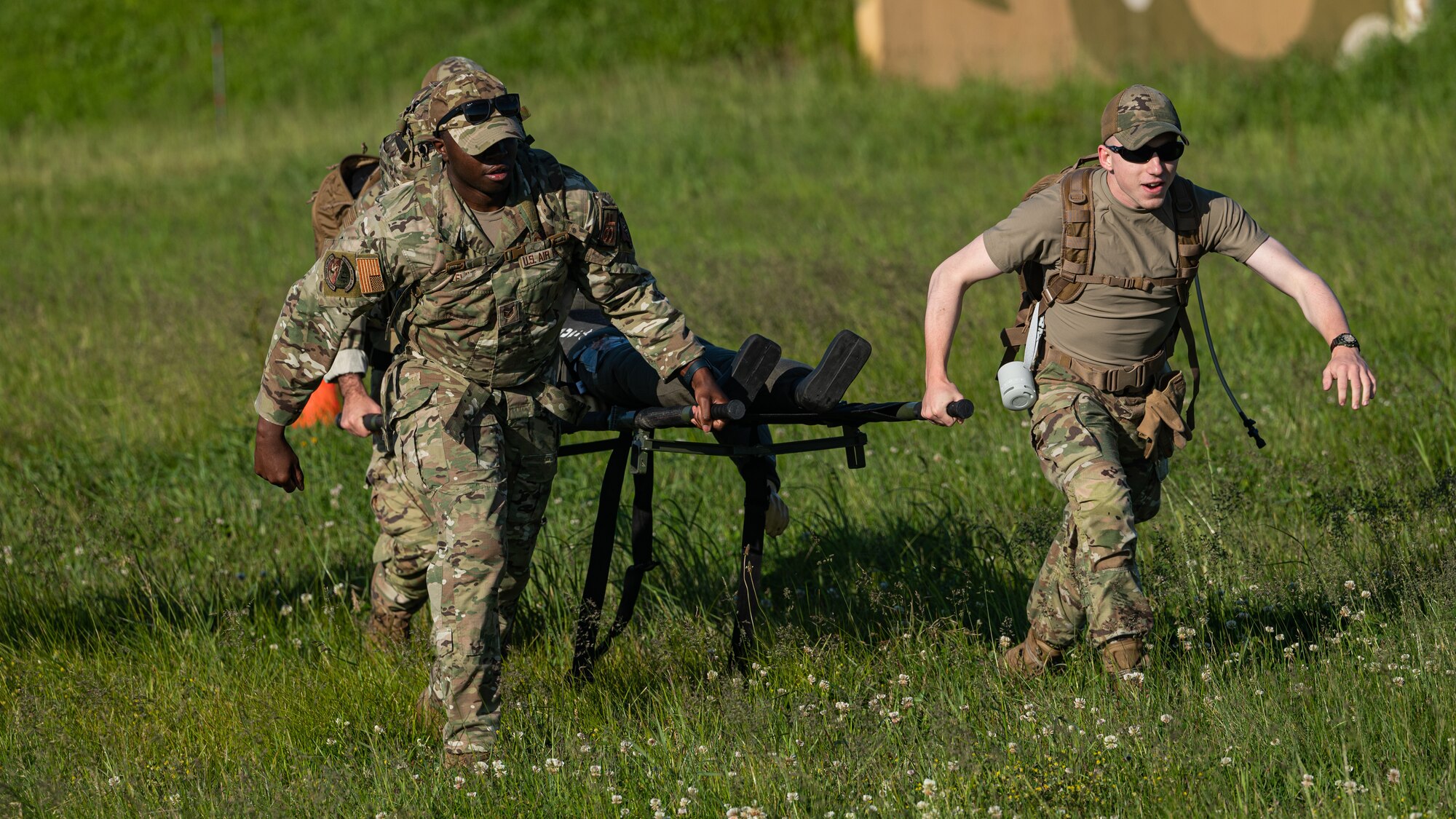 Staff Sgt. Trajan Lewis and Airman Justin Shult perform simulated tactical combat care on a training mannequin.