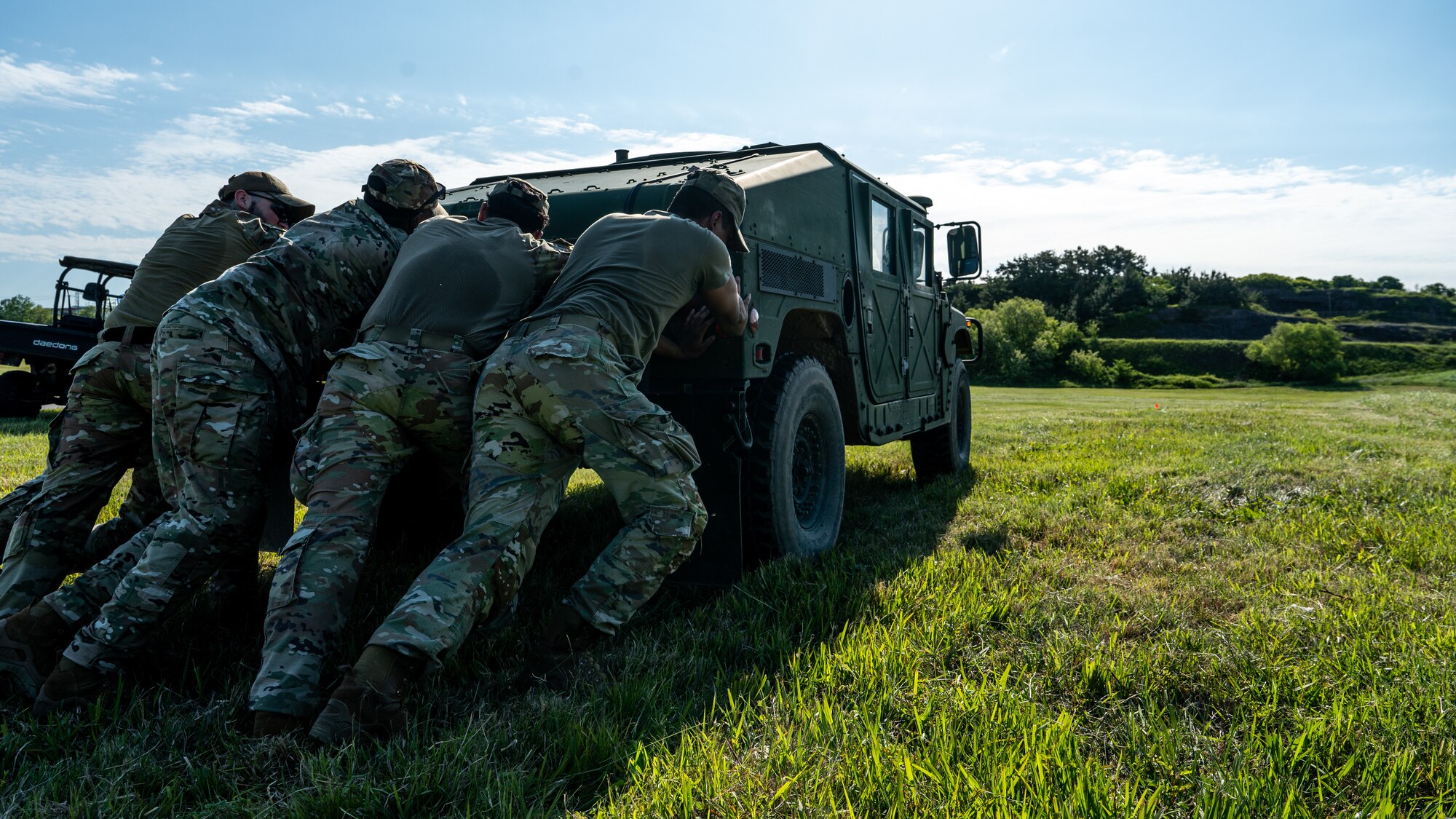 8th Security Forces Squadron Airmen perform a humvee push as part of an obstacle course.