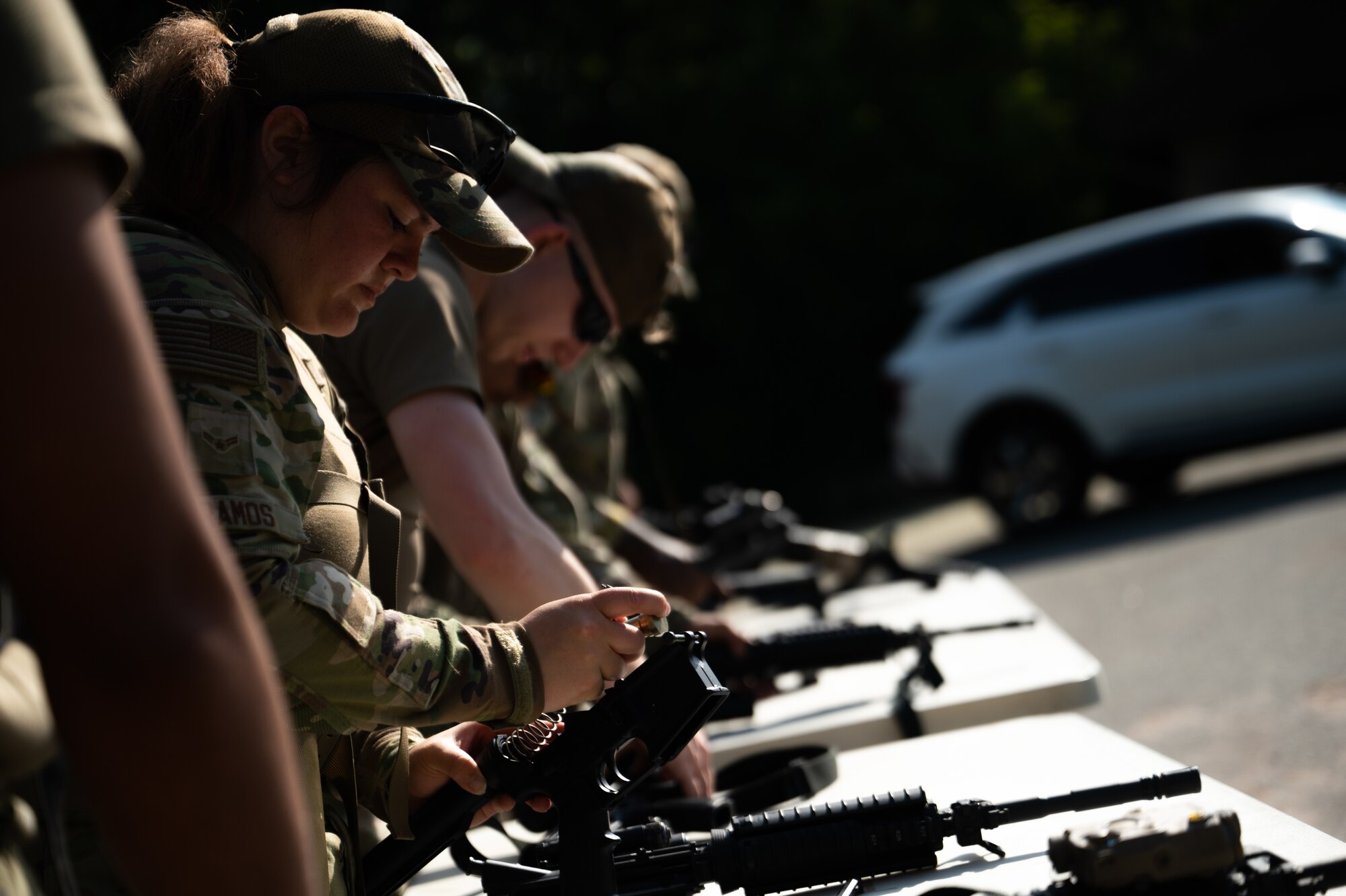 Airman 1st Class Meghan Ramos breaks down an M4 carbine rifle during an obstacle course for Police Week.
