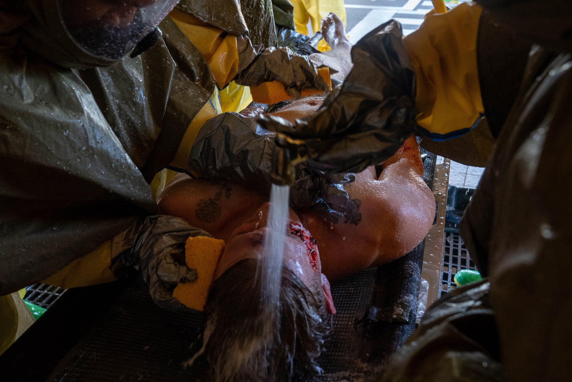 Airmen gets there face washed during a DECON shower
