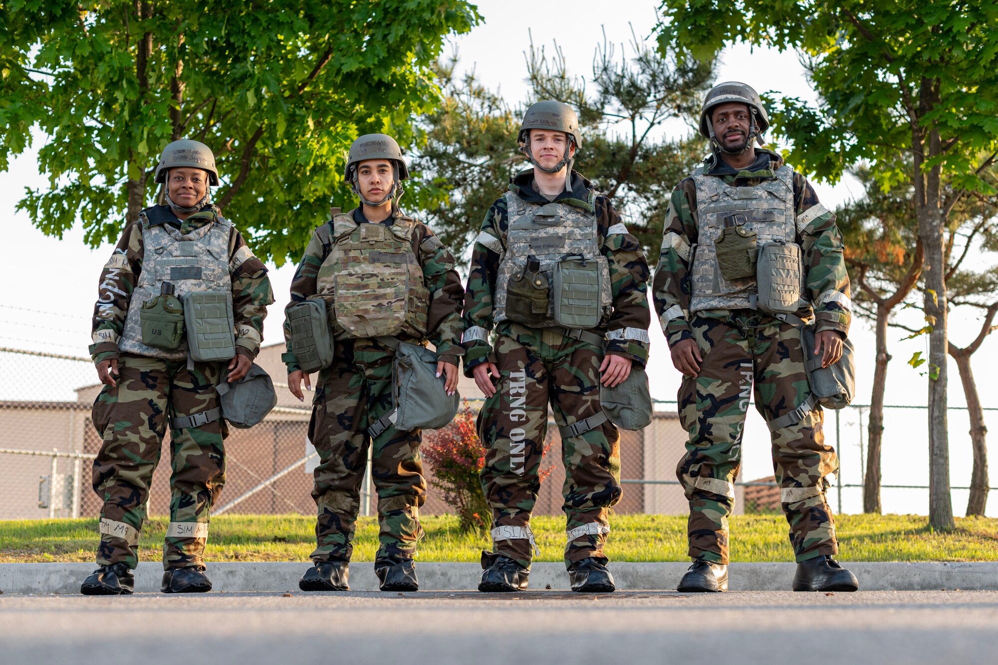 U.S. Air Force Airmen assigned to the 51st Operations Support Squadron, stand abreast in mission-oriented protective posture level two during Beverly Herd 24-1 at Osan Air Base, Republic of Korea, May 16, 2024. The 51st OSS is responsible for training, flight operations, intelligence, operational plans, airfield management and weather forecasting to enable the 51st Fighter Wing to execute the mission. Routine training events like Beverly Herd are pivotal platforms for 51st Fighter Wing Airmen to refine their warfighting proficiencies through practical application, concurrently enhancing their ability to respond skillfully to contingencies.  (U.S. Air Force photo by Staff Sgt. Aubree Owens)