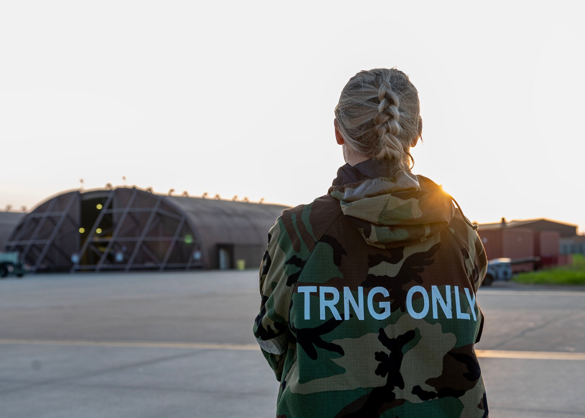 U.S. Air Force Senior Airman Sabrina Fuller-Judd, 51st Fighter Wing Public Affairs journeyman, observes the flight line during Beverly Herd 24-1 at Osan Air Base, Republic of Korea, May 16, 2024. The 51st FW PA office is charged with historically documenting and archiving the mission and people of the 51st FW. Routine training events like Beverly Herd are pivotal platforms for 51st Fighter Wing Airmen to refine their warfighting proficiencies through practical application, concurrently enhancing their ability to respond skillfully to contingencies. (U.S. Air Force photo by Staff Sgt. Aubree Owens)