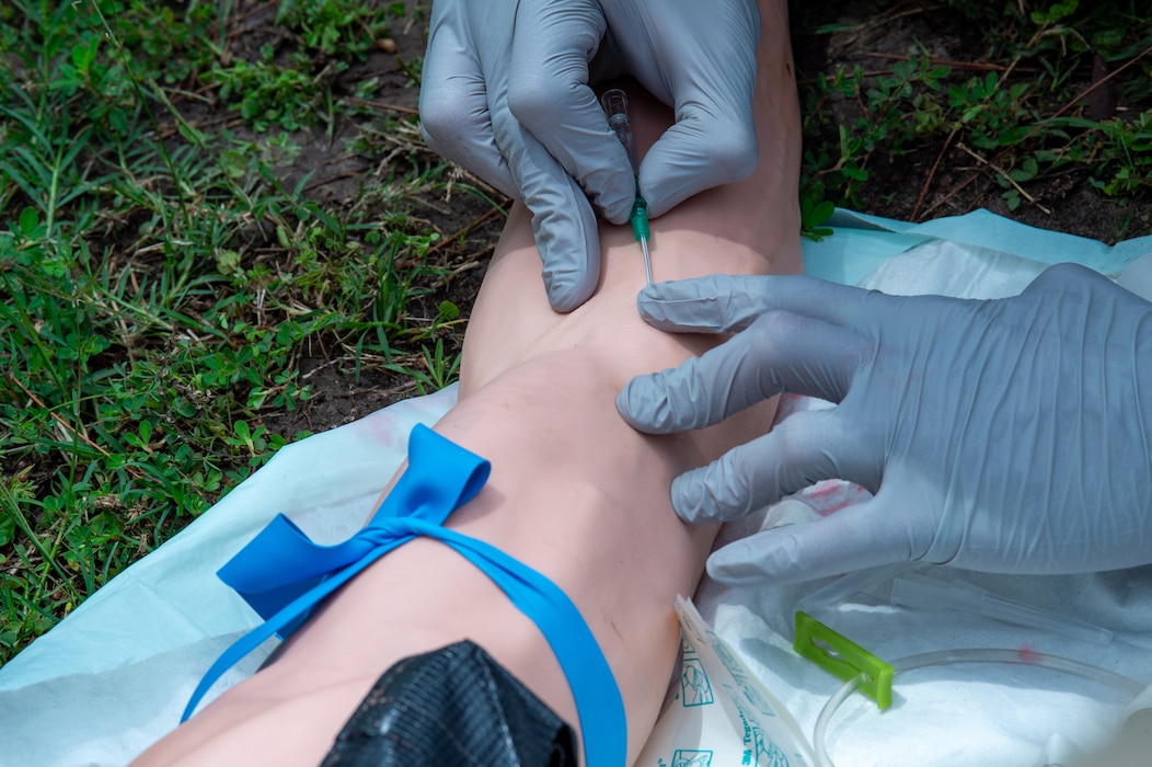 A U.S. Air Force Airman assigned to the 23rd Medical Group practices placing an I.V. during the Readiness Rodeo at Moody Air Force Base, Georgia, May 10, 2024. The use of a simulated appendage allows the participants to learn how to properly place an I.V. without the threat of harming a live patient. (U.S. Air Force photo by Airman 1st Class Iain Stanley)