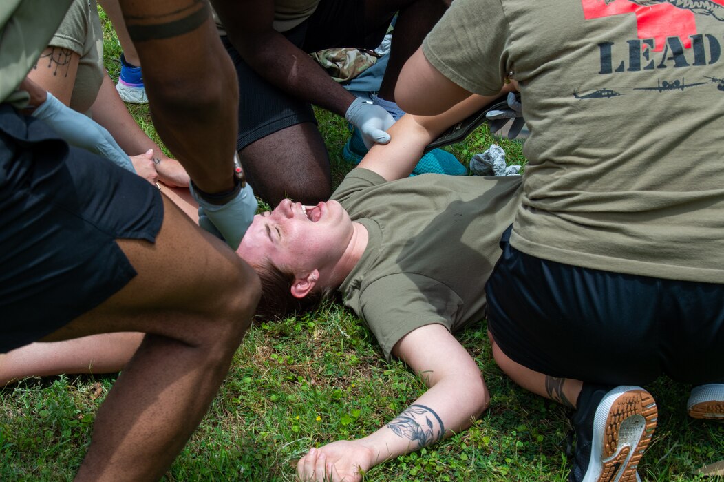 U.S. Air Force Airmen assigned to the 23rd Medical Group practice treating a combative patient during the Readiness Rodeo at Moody Air Force Base, Georgia, May 10, 2024. The screaming and pushing from the patient propels participants into an enhanced state of thinking under stress. (U.S. Air Force photo by Airman 1st Class Iain Stanley)