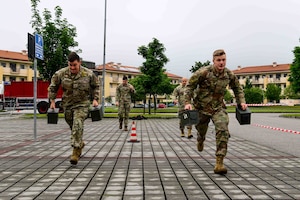 Two Air Force members perform an Ammo can carry