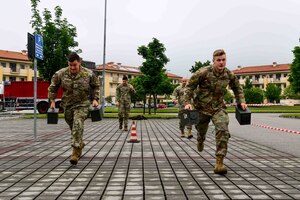 Two Air Force members perform an Ammo can carry