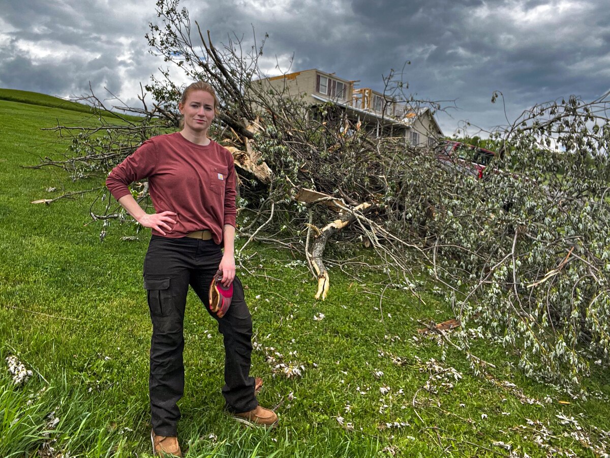 Senior Master Sgt. Maranda Jordan stands near tree thrown by a tornado, May 10, 2024, Chester, West Virginia. Jordan utilized social media to organize a local volunteer effort and donations for families in her tornado-struck hometown. (Courtesy photo)