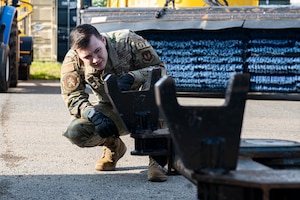 U.S. Air Force Senior Airman Christopher Searle, 100th Logistics Readiness Squadron ground transportation operator, gauges the height of a tow bar during the base readiness exercise Aw-R-Go at Royal Air Force Mildenhall, England, May 15, 2024.