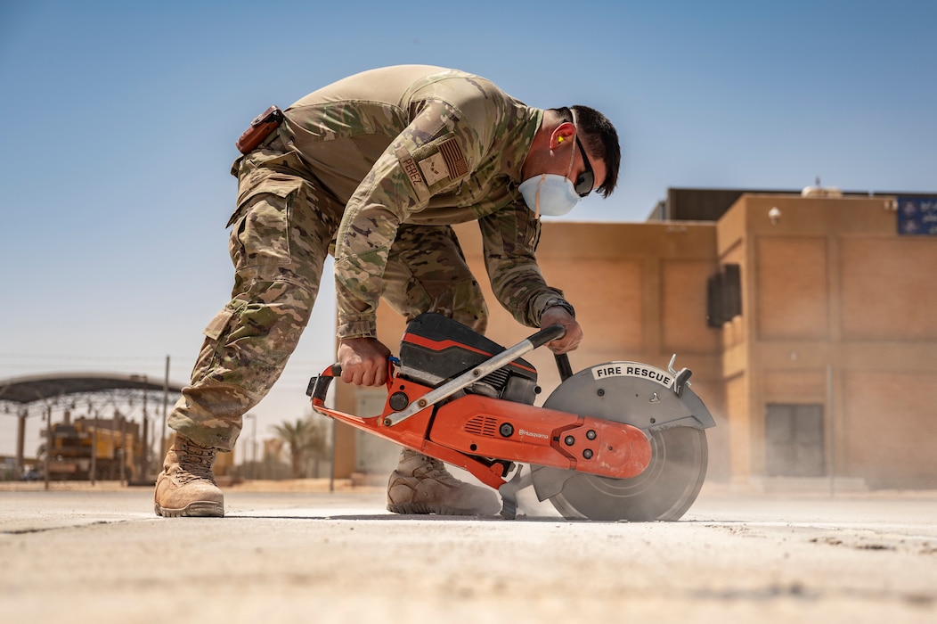 A U.S. Air Force pavement and equipment technician assigned to the 378th Expeditionary Civil Engineer Squadron cuts concrete