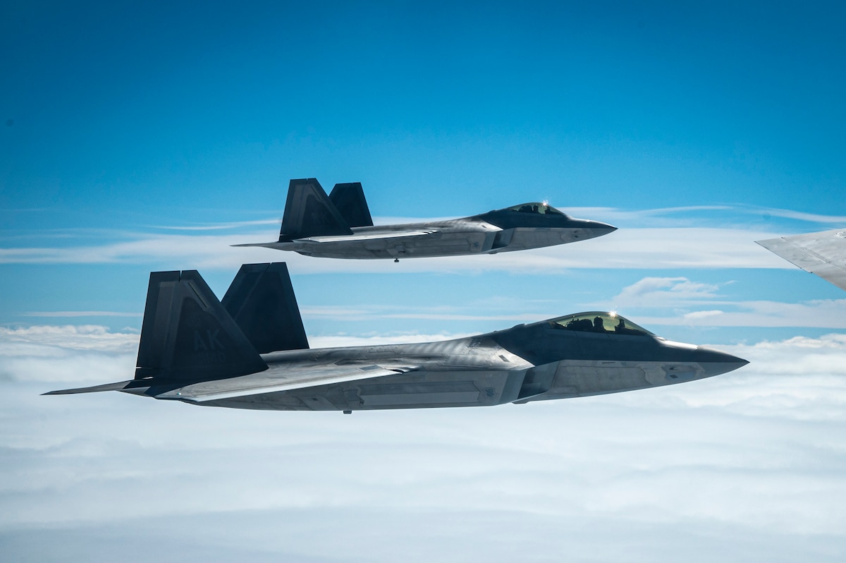 Two F-22 Raptors fly in formation with a KC-135 Stratotanker during exercise Royal Flush over Alaska, May 4, 2024. Royal Flush is an Air Mobility Command readiness exercise that evaluates the ability to rapidly respond and execute mobility fundamentals and non-standard techniques to provide global mobility at a moment’s notice. (U.S. Air Force photo by Staff Sgt. Ryan Gomez)