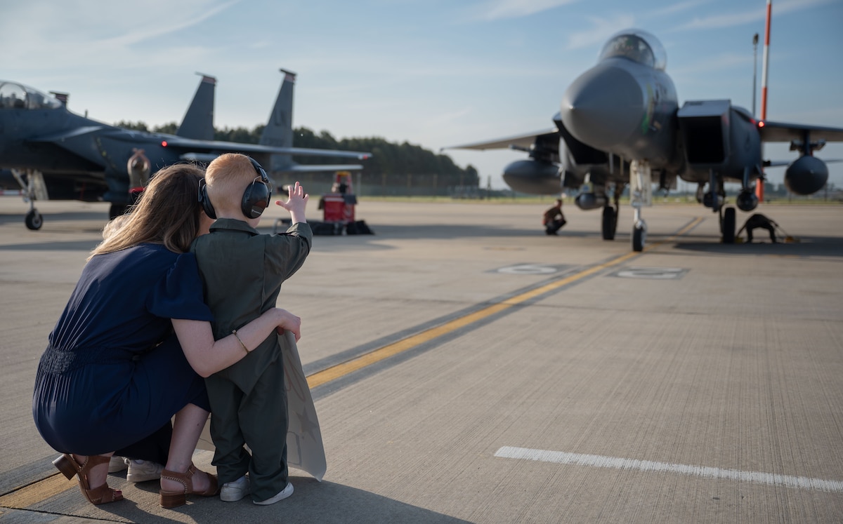 Margaret Snider and her children wait to reunite with her husband, U.S. Air Force Maj. Tyson Snider, 494th Fighter Squadron pilot, at RAF Lakenheath, United Kingdom, May 10, 2024. The 494th FS returned from a seven-month deployment to an undisclosed location in Southwest Asia, where they provided crucial support to operations in the U.S. Central Command area of responsibility. (U.S. Air Force photo by Senior Airman Renee Nicole S.N. Finona)