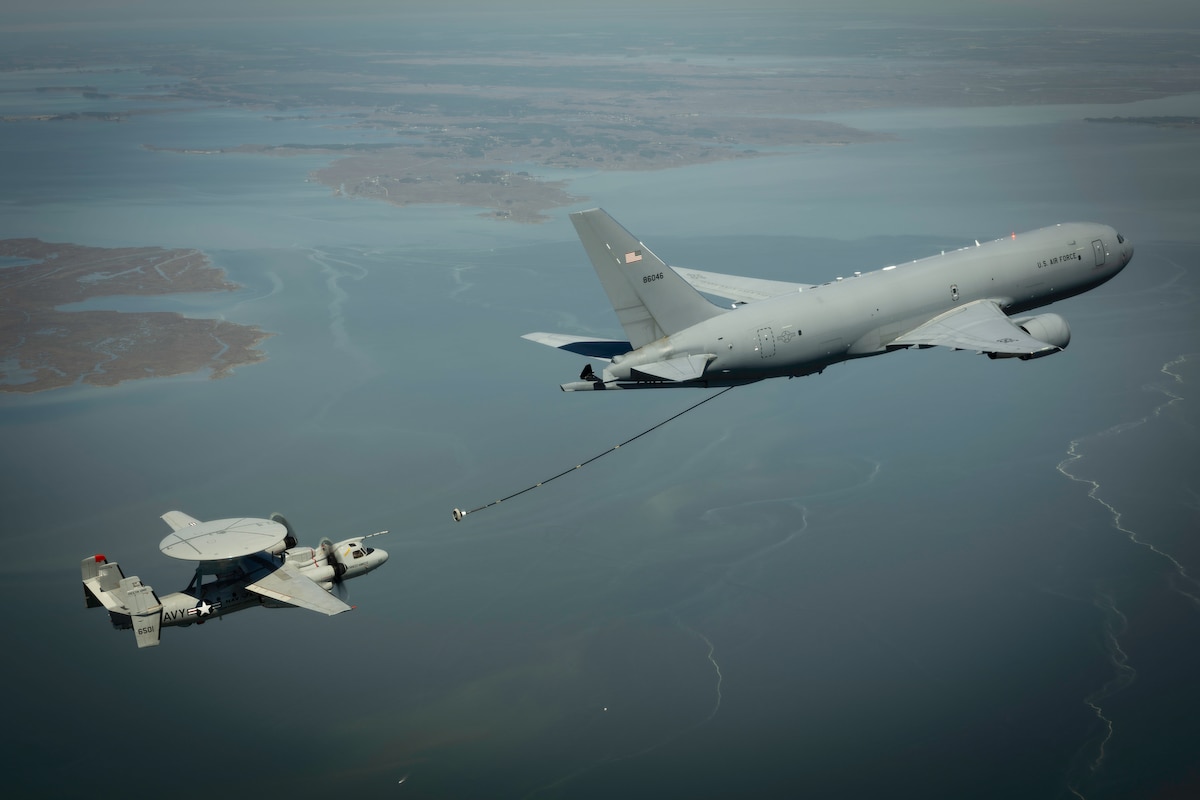 A KC-46A Pegasus conducts tanker-receiver aerial refueling compatibility testing with an E-2D Advanced Hawkeye from the U.S. Navy’s Air Test and Evaluation Squadron (VX) 20 over Patuxent River, Md., May 15, 2024. Certifying the tanker-receiver pair will sustain the E-2D aerial refueling capability as the Air Force modernizes its tanker fleet, ultimately extending the airborne early warning, battle management, and integrated air and missile defense missions through significantly increased persistence and range. (U.S. Navy photo by Erik Hildebrandt)