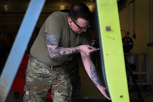 U.S. Air Force Staff Sgt. Joshua Wilson, 100th Maintenance Squadron aircraft structural maintenance craftsman, creates holes to simulate damage to an aircraft panel during the base readiness exercise Aw-R-Go at Royal Air Force Mildenhall, England, May 14, 2024.
