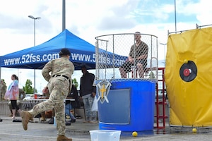 A man throws a ball at a target.