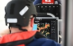 A crew member from Coast Guard Station Portsmouth looks over the radar while underway for two-boat tactical coxswain training in Portsmouth, Virginia on Aug. 22, 2023. Tactical Coxswains and crew members normally attend a two week developmental course at Special Missions Training Center at Camp Lejeune, North Carolina, where they practice and perform until the member demonstrates proficiency in the mission requirements. (U.S. Coast Guard Photo by Petty Officer 2nd Class Ryan L. Noel)