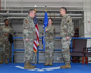 U.S. Air Force Col. Bruce Guest, 509th Maintenance Group commander, left, and Maj. Sean Christy, former 509th Aircraft Maintenance Squadron commander and now 393d Bomber Generation Squadron commander, right, perform deactivation of the 509th AMXS and activation of the 393d BGS at Whiteman Air Force Base, Mo., May 17, 2024. The change from the 509th AMXS to the 393d BGS helps align the maintenance unit with its operations counterparts. (U.S. Air Force photo by Senior Airman Bryson Britt)