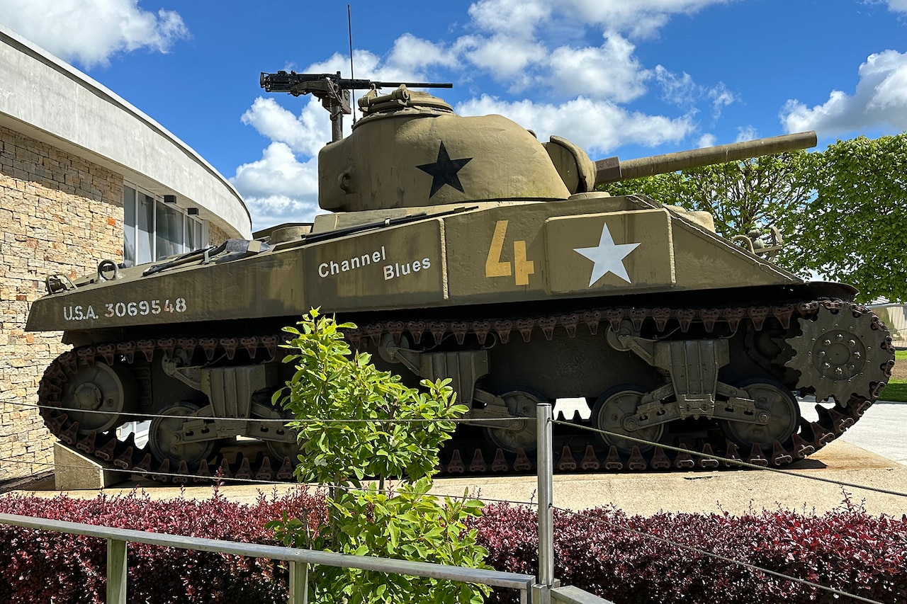 A tank is on display outside a museum.
