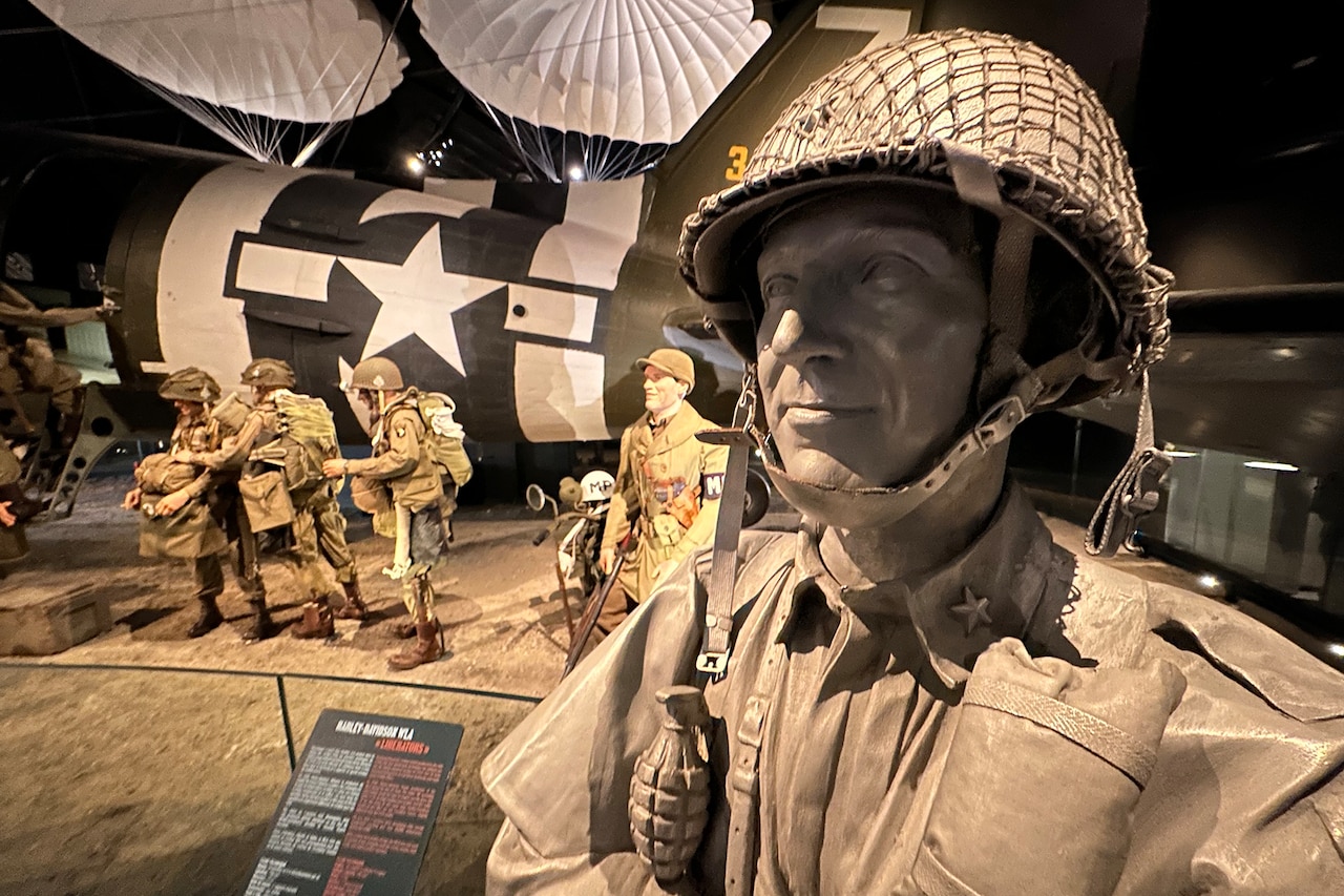 Statues of service members in uniform.
