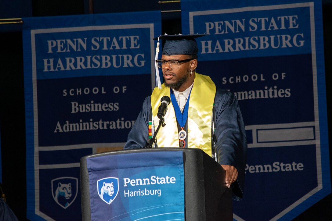 U.S. Army Sgt. Ashon Calhoun, a public affairs specialist with the 109th Mobile Public Affairs Detachment, 213 Regional Support Group, Pennsylvania National Guard, gives a commencement speech during the Penn State Harrisburg 2024 graduation ceremony at the Giant Center at Hershey, Pennsylvania, May 4, 2024. Calhoun graduated summa cum laude, was his class marshal and was selected as the only student speaker during the ceremony. (Courtesy Photo by Sharon Siegfried)